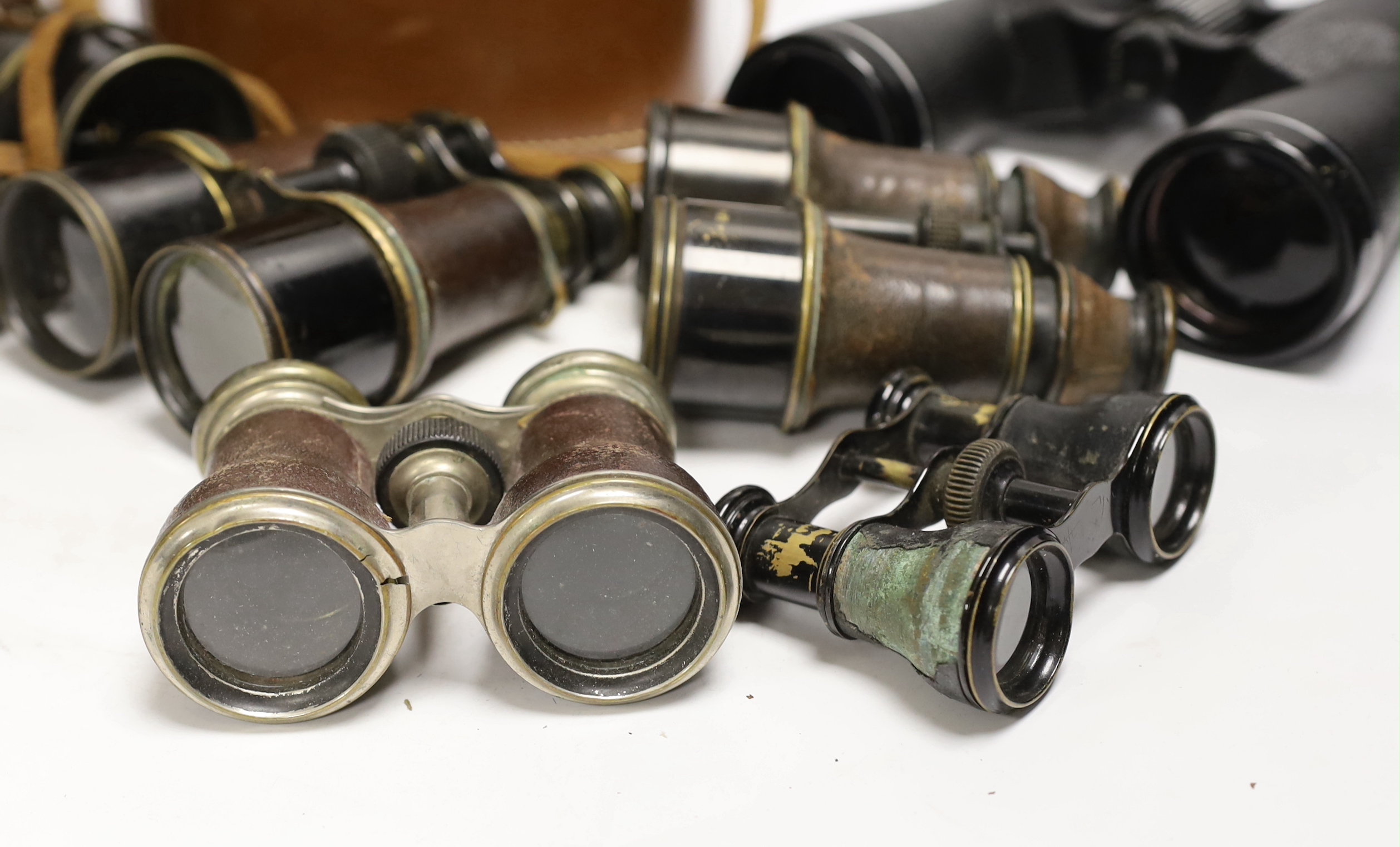 Seven pairs of binoculars including some early 20th century examples, a pair by Ross, etc.